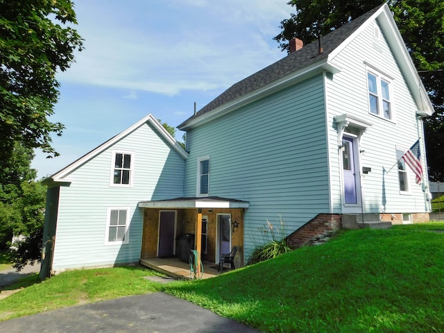 124 Church St, Dexter, ME 04930 - view of front of house featuring a front lawn and a chimney
