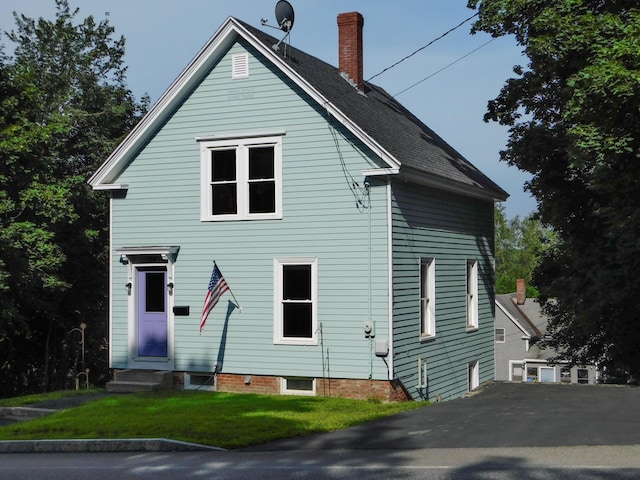 124 Church St, Dexter, ME 04930 - back of property featuring entry steps, a chimney, and a lawn