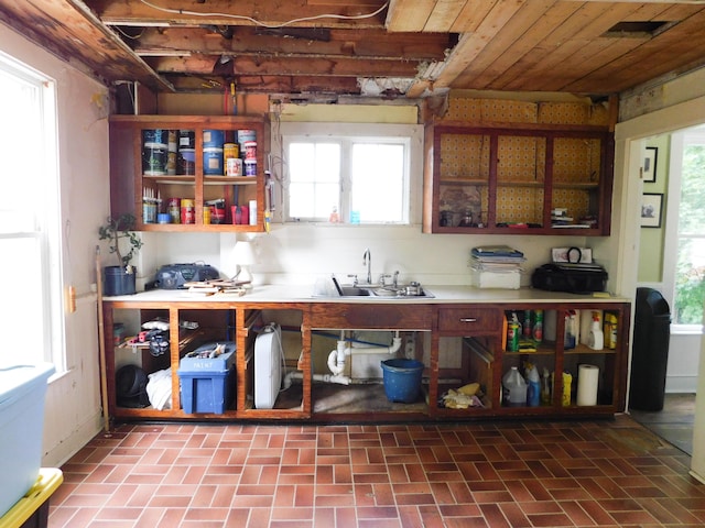 124 Church St, Dexter, ME 04930 - kitchen with brick patterned flooring, a sink, and light countertops