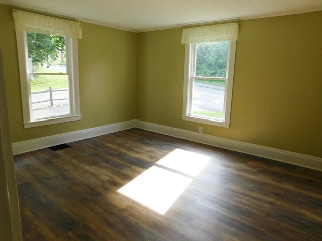 124 Church St, Dexter, ME 04930 - spare room featuring dark wood-style floors, ornamental molding, and baseboards