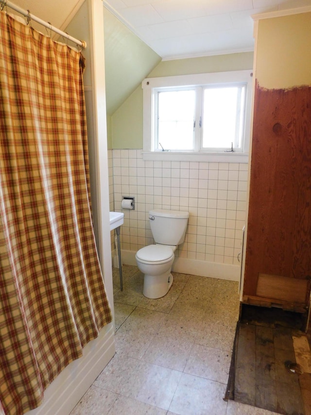 124 Church St, Dexter, ME 04930 - bathroom with toilet, vaulted ceiling, tile walls, curtained shower, and tile patterned floors