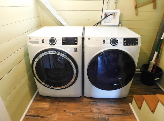 124 Church St, Dexter, ME 04930 - washroom with separate washer and dryer, wood finished floors, and wood walls