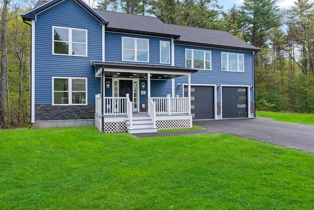 15 Stone Ledge Dr, Lewiston, ME 04240 - view of front facade with covered porch, driveway, an attached garage, a front yard, and stone siding