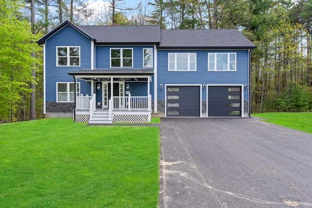15 Stone Ledge Dr, Lewiston, ME 04240 - view of front of home with a porch, an attached garage, driveway, and a front lawn