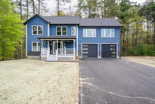 15 Stone Ledge Dr, Lewiston, ME 04240 - view of front of home featuring a porch, driveway, an attached garage, and a shingled roof