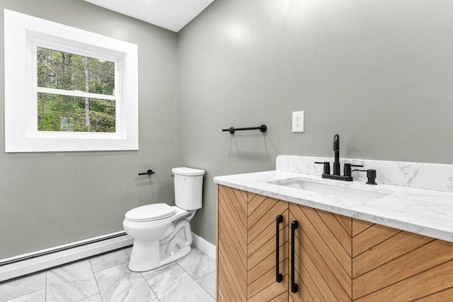 15 Stone Ledge Dr, Lewiston, ME 04240 - half bathroom with a baseboard heating unit, toilet, baseboards, vanity, and marble finish floors