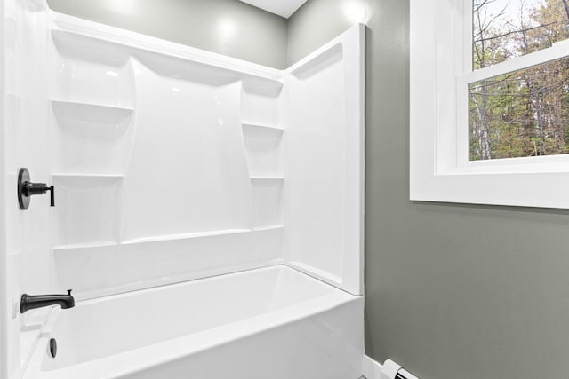 15 Stone Ledge Dr, Lewiston, ME 04240 - bathroom featuring baseboards, washtub / shower combination, and baseboard heating