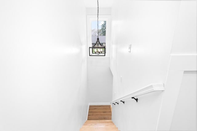 15 Stone Ledge Dr, Lewiston, ME 04240 - staircase with wood finished floors, baseboards, and a chandelier