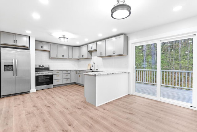 15 Stone Ledge Dr, Lewiston, ME 04240 - kitchen with stainless steel appliances, gray cabinets, decorative backsplash, light wood-style flooring, and recessed lighting