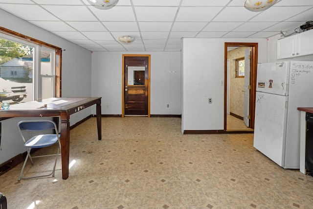 501 Knox St, Rumford, ME 04276 - dining room featuring a paneled ceiling, light flooring, and baseboards