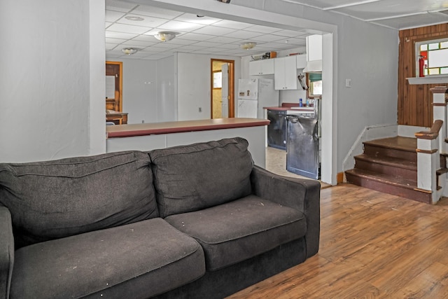 501 Knox St, Rumford, ME 04276 - living area with light wood-type flooring, stairs, and a drop ceiling