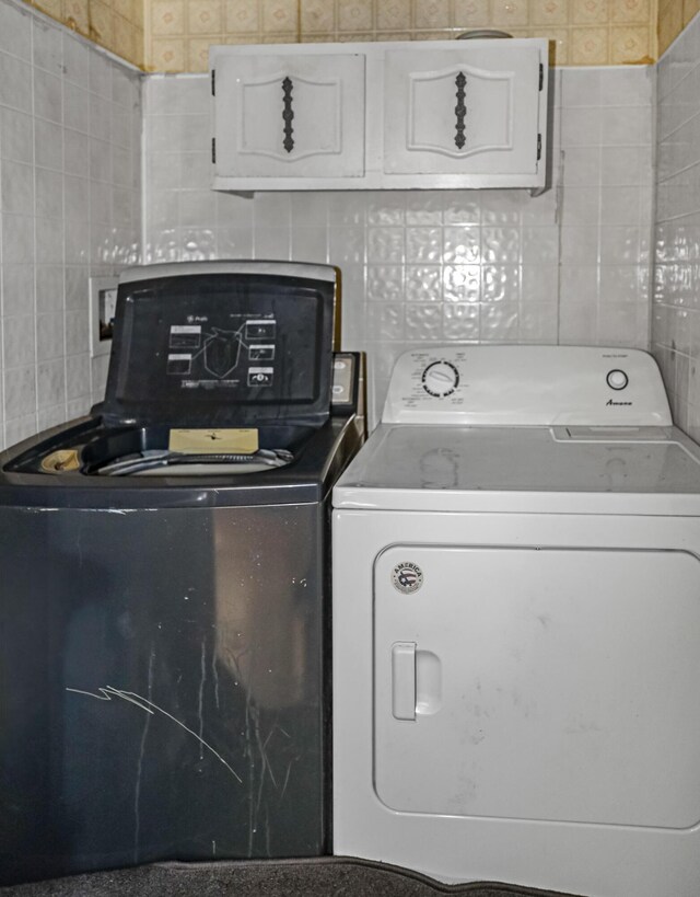 501 Knox St, Rumford, ME 04276 - laundry area with cabinet space, separate washer and dryer, and tile walls
