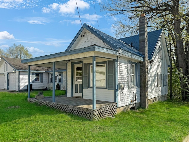 501 Knox St, Rumford, ME 04276 - back of house featuring metal roof, a chimney, and a yard