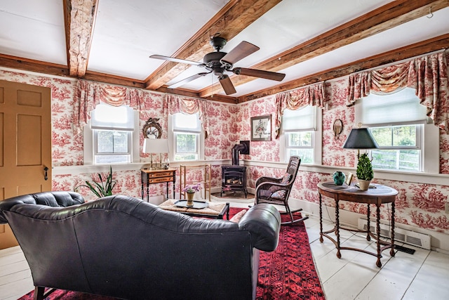 321 Clarks Bridge Rd, Waterboro, ME 04061 - living room featuring wallpapered walls, a baseboard heating unit, a wood stove, plenty of natural light, and beamed ceiling