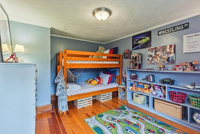 286 Canaan Rd, Clinton, ME 04927 - bedroom with crown molding, a textured ceiling, and wood finished floors