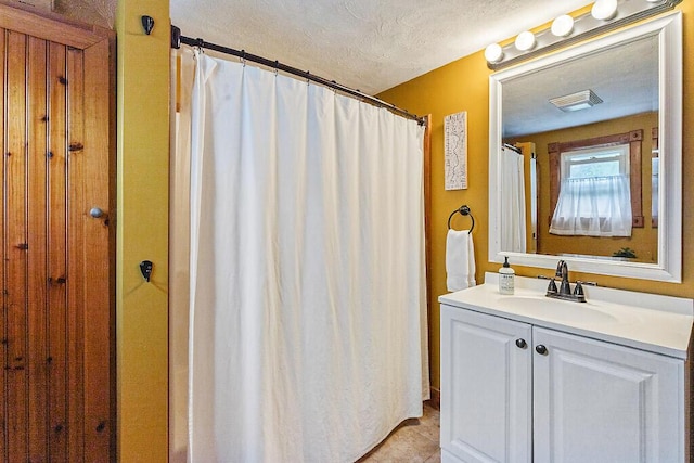 286 Canaan Rd, Clinton, ME 04927 - bathroom with a textured ceiling, vanity, tile patterned floors, and curtained shower