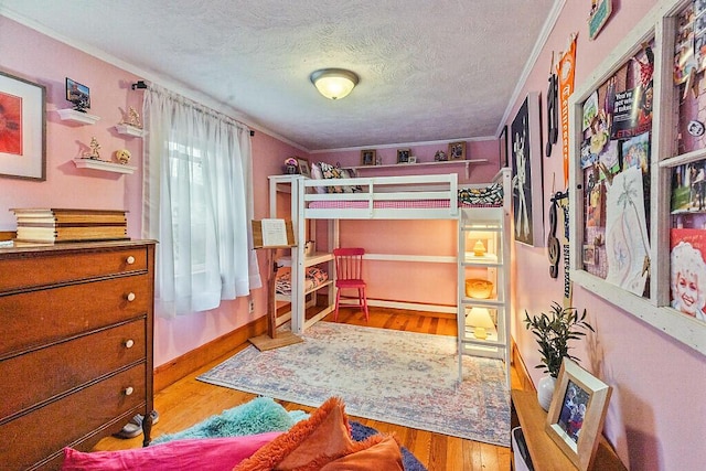 286 Canaan Rd, Clinton, ME 04927 - bedroom featuring crown molding, wood finished floors, and a textured ceiling