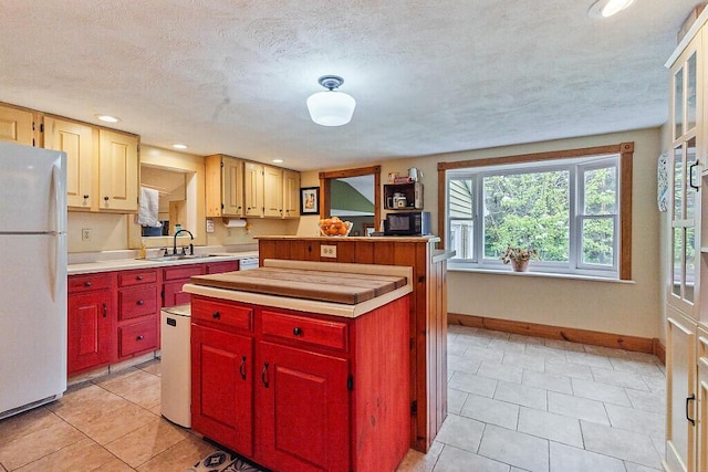 286 Canaan Rd, Clinton, ME 04927 - kitchen featuring freestanding refrigerator, a sink, baseboards, light countertops, and light tile patterned floors
