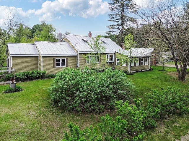 286 Canaan Rd, Clinton, ME 04927 - back of house with a chimney, a yard, metal roof, and a standing seam roof