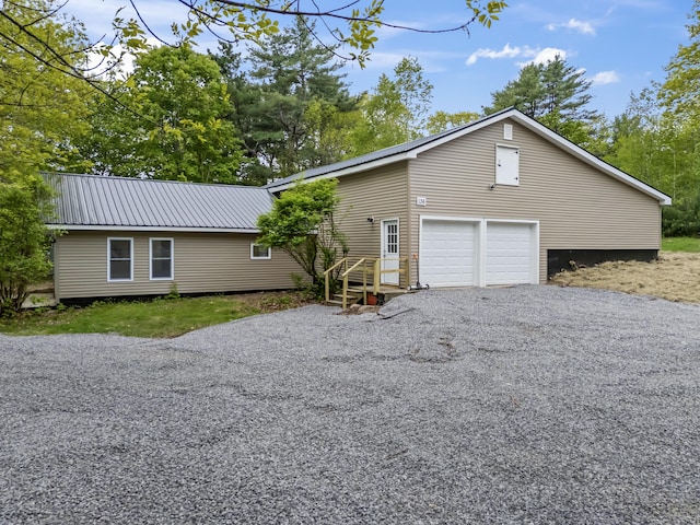 136 Costello Rd, Gardiner, ME 04345 - view of front of house with metal roof and a garage