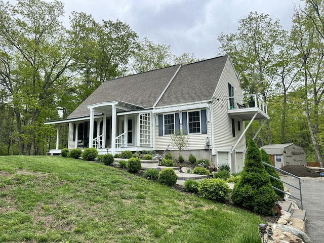 239 Cider Hill Rd, York, ME 03909 - view of front of home featuring a balcony, roof with shingles, covered porch, an attached garage, and a front lawn
