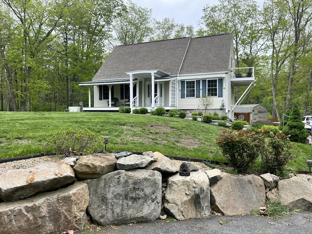 239 Cider Hill Rd, York, ME 03909 - view of front of home with covered porch, a front yard, and roof with shingles