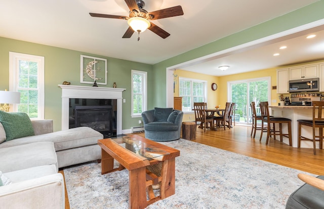 239 Cider Hill Rd, York, ME 03909 - living area featuring light wood-type flooring, baseboard heating, plenty of natural light, ceiling fan, and recessed lighting