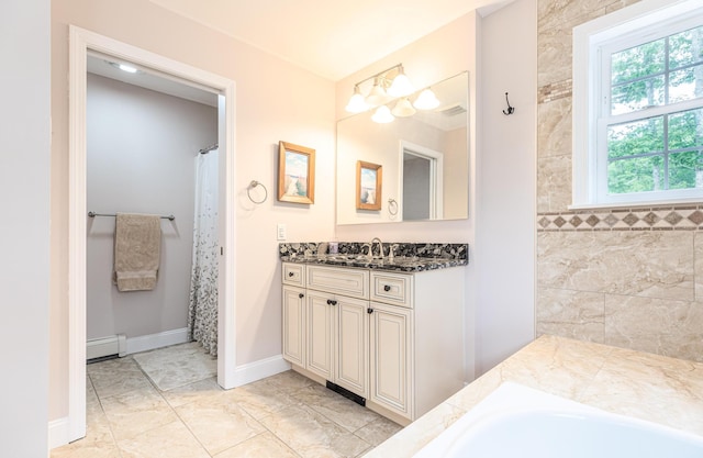 239 Cider Hill Rd, York, ME 03909 - bathroom with baseboard heating, marble finish flooring, vanity, baseboards, and a tub