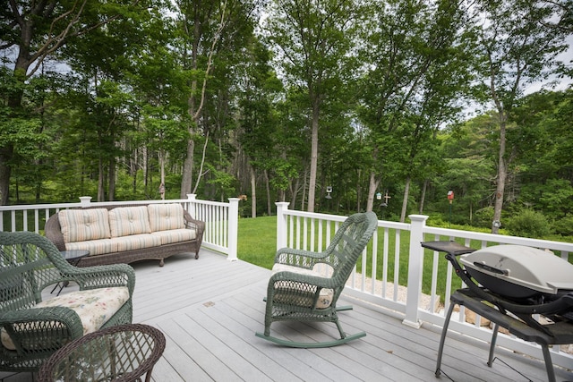 239 Cider Hill Rd, York, ME 03909 - wooden deck with view of wooded area, an outdoor living space, and a lawn