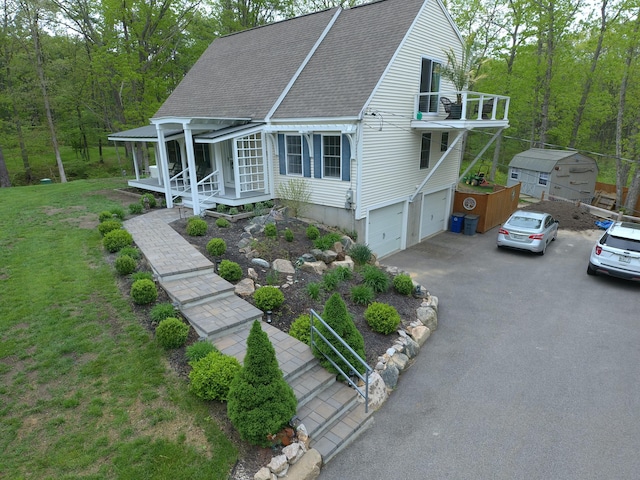 239 Cider Hill Rd, York, ME 03909 - view of front of property featuring a shingled roof, driveway, an attached garage, a porch, and a wooded view