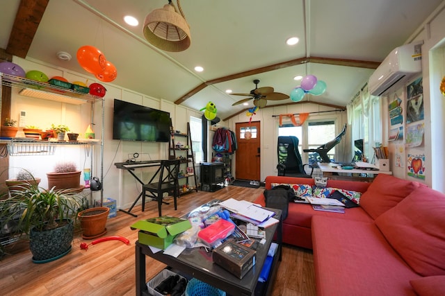 486 Main St, Orono, ME 04473 - living area featuring an AC wall unit, wood finished floors, vaulted ceiling, healthy amount of natural light, and a ceiling fan
