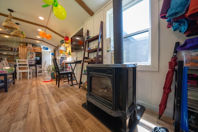 486 Main St, Orono, ME 04473 - living room with a wood stove, vaulted ceiling, and wood finished floors