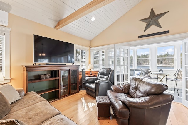 159 Loop Rd, Acton, ME 04001 - living room featuring light wood-style floors, high vaulted ceiling, plenty of natural light, wood ceiling with exposed beams, and a wall mounted air conditioner