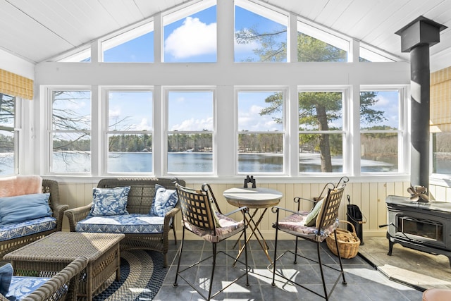159 Loop Rd, Acton, ME 04001 - sunroom with lofted ceiling, plenty of natural light, a wood stove, and a water view
