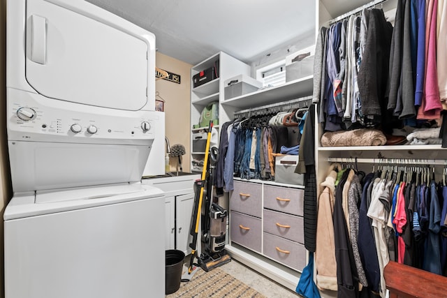 159 Loop Rd, Acton, ME 04001 - laundry area featuring stacked washer and clothes dryer and cabinet space