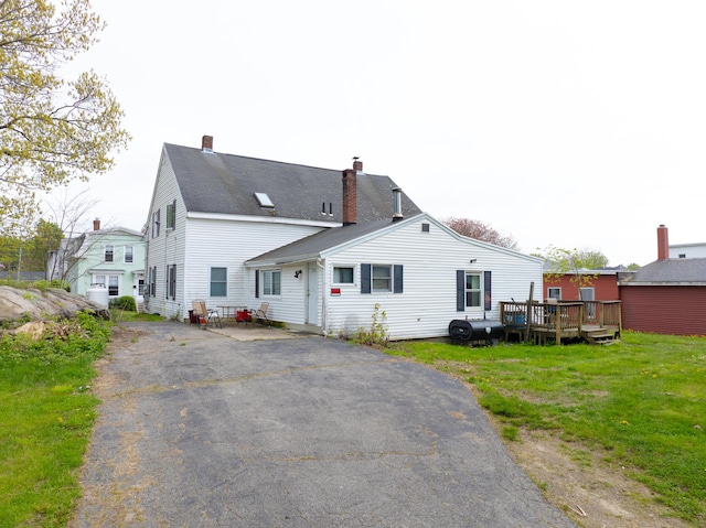 138 Summer St, Biddeford, ME 04005 - back of property featuring a chimney, a deck, a lawn, and heating fuel