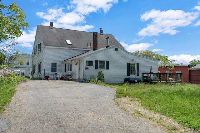 138 Summer St, Biddeford, ME 04005 - rear view of property with a wooden deck, a chimney, and asphalt driveway