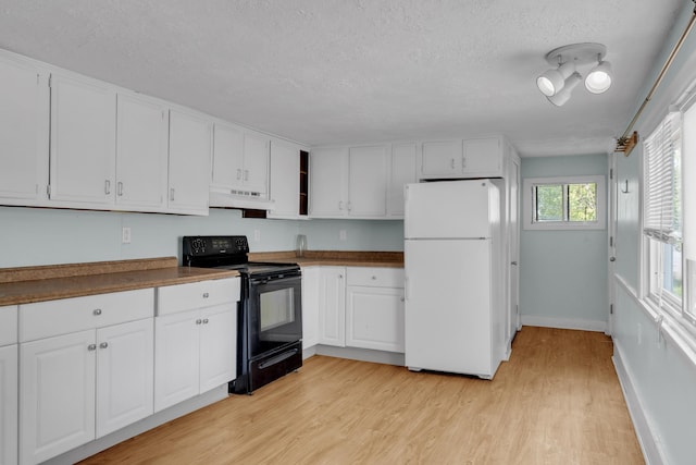 138 Summer St, Biddeford, ME 04005 - kitchen with freestanding refrigerator, electric range, ventilation hood, a textured ceiling, and white cabinetry