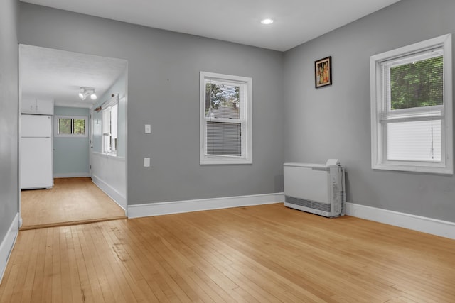 138 Summer St, Biddeford, ME 04005 - unfurnished room with heating unit, light wood finished floors, plenty of natural light, and recessed lighting