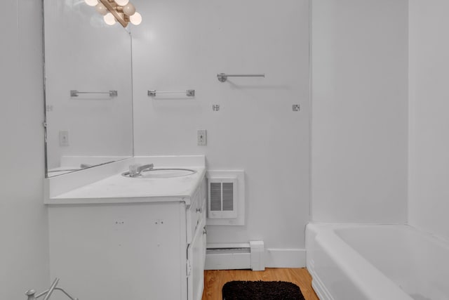 138 Summer St, Biddeford, ME 04005 - full bath with vanity, a baseboard radiator, and wood finished floors
