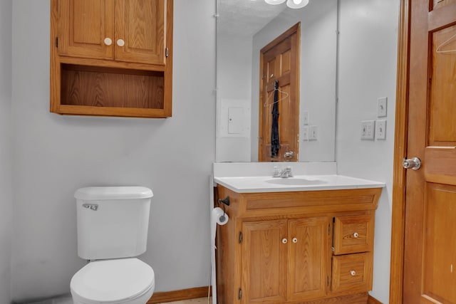 138 Summer St, Biddeford, ME 04005 - half bathroom with toilet, vanity, and baseboards
