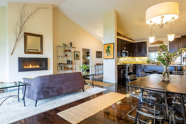 1496 Atlantic Hwy, Northport, ME 04849 - dining area featuring a glass covered fireplace and lofted ceiling