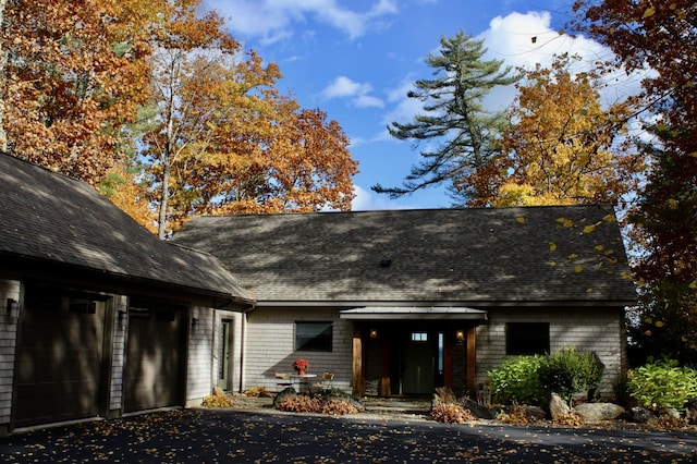 1496 Atlantic Hwy, Northport, ME 04849 - back of property featuring a shingled roof, asphalt driveway, and a garage