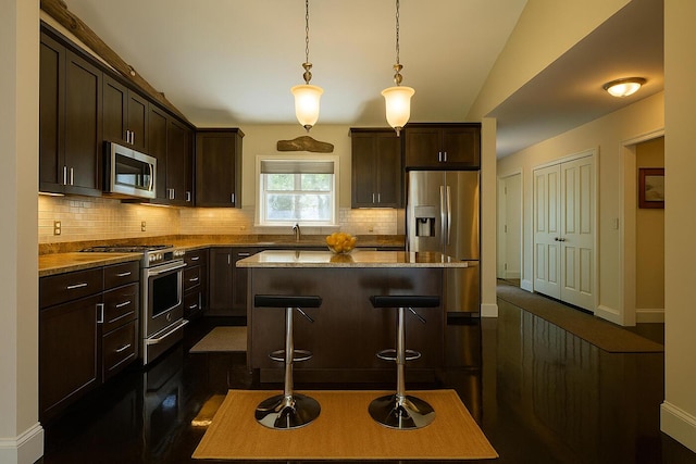 1496 Atlantic Hwy, Northport, ME 04849 - kitchen featuring stainless steel appliances, tasteful backsplash, dark brown cabinetry, and a breakfast bar