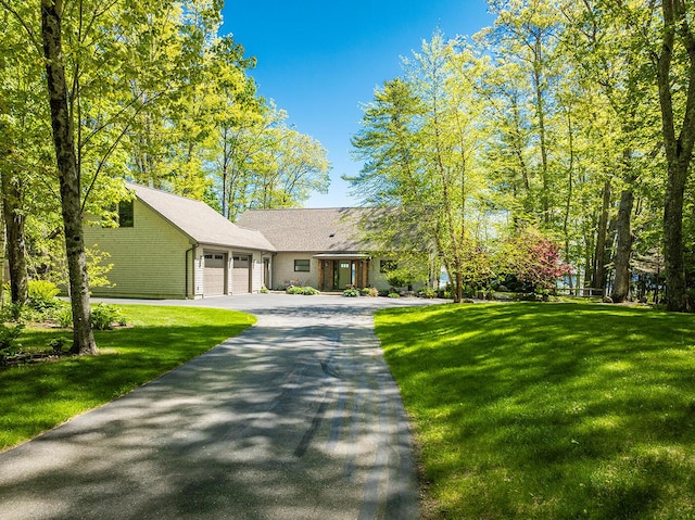 1496 Atlantic Hwy, Northport, ME 04849 - view of front of property featuring an attached garage, driveway, and a front yard