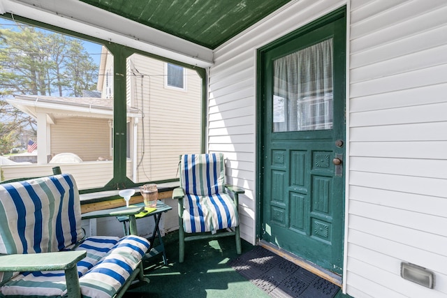 view of exterior entry with a porch