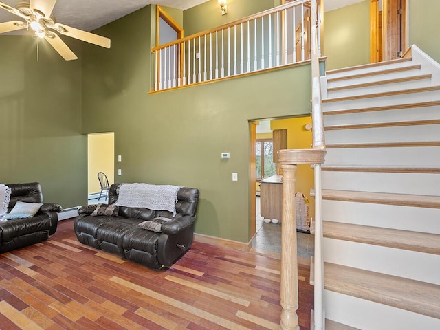 19 Falls Rd, Benton, ME 04901 - living room featuring ceiling fan, a high ceiling, stairs, wood finished floors, and baseboards