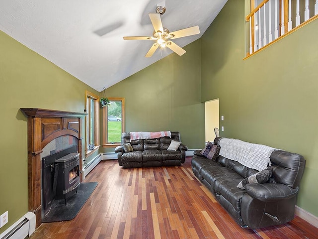 19 Falls Rd, Benton, ME 04901 - living area featuring a baseboard heating unit, hardwood / wood-style flooring, ceiling fan, a wood stove, and high vaulted ceiling