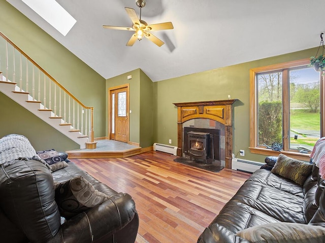 19 Falls Rd, Benton, ME 04901 - living area featuring a baseboard radiator, light wood-style flooring, stairway, ceiling fan, and high vaulted ceiling