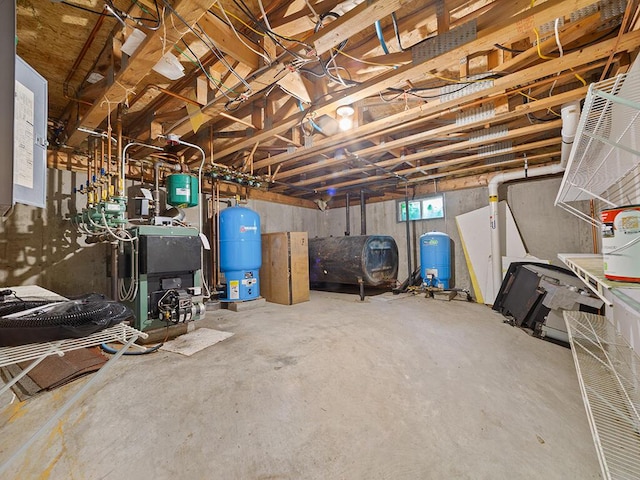 19 Falls Rd, Benton, ME 04901 - basement with a water pressure tank, oil tank, and a heating unit